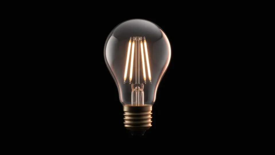 LED-Fadenlampe mit warm leuchtenden Fäden vor schwarzem Grund.